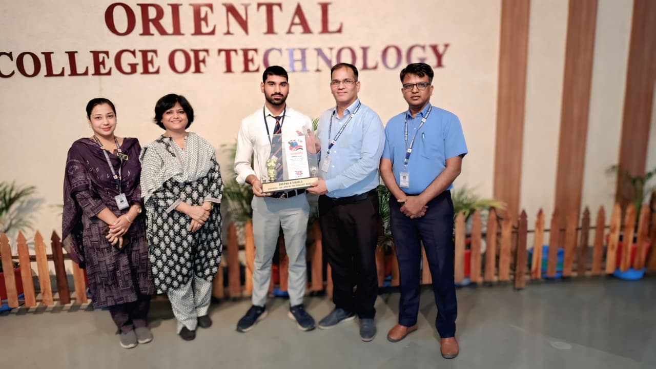 Deepak receiving recognition at Oriental College of Technology